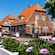 Low slung brick houses with tile roofs and flower boxes along and flower boxes along the streets of Skagen, Denmark